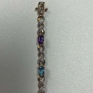 Vintage gold tone bracelet with multi colored gems. Signed with 925 R China.